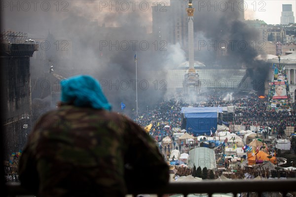 Kiev, Ukraine. 20th Feb, 2014. A view of maidan square with a protester during clashes in central Kiev. At least 25 protesters were killed on February 20 in fresh clashes between thousands of demonstrators and heavily-armed riot police in the heart of Kiev, AFP correspondents at the scene said Credit:  ZUMA Press, Inc./Alamy Live News