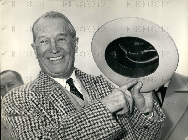 Nov. 11, 1959 - Maurice Chevalier swops boater for Cowboy hat. Back from Hollywood Maurice Chevalier arrived at Orly Airport this afternoon. OPS: Maurice showing the cowboy hat he brought from California after landing at Orly this afternoon. Nov. 5/59