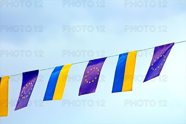 Flags of European Union and Ukraine over blue sky
