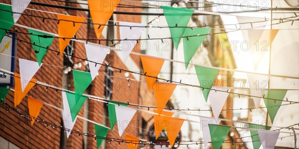 Garland with irish flag colors in a street of Dublin, Ireland - Saint Patrick day celebration concept