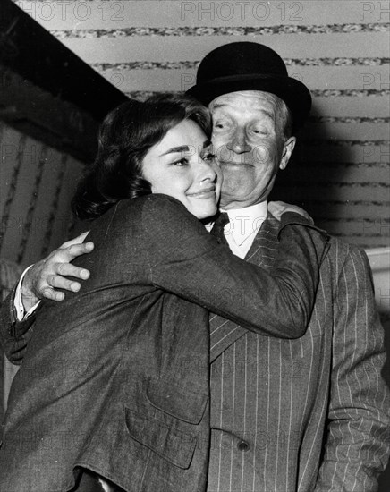 Audrey Hepburn embracing Maurice Chevalier during the making of the film, "Love In The Afternoon" 1957 Allied Artists File Reference # 33536_265THA