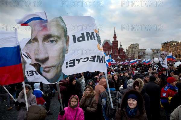 People at the rally-concert "We are together" in support of the annexation of Crimea and Sevastopol to Russia on Red square of Moscow on March 18,2014