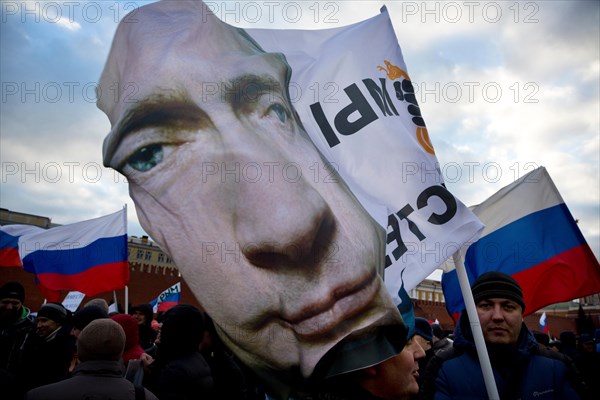 People at the rally-concert "We are together" in support of the annexation of Crimea and Sevastopol to Russia on Red square of Moscow on March 18,2014