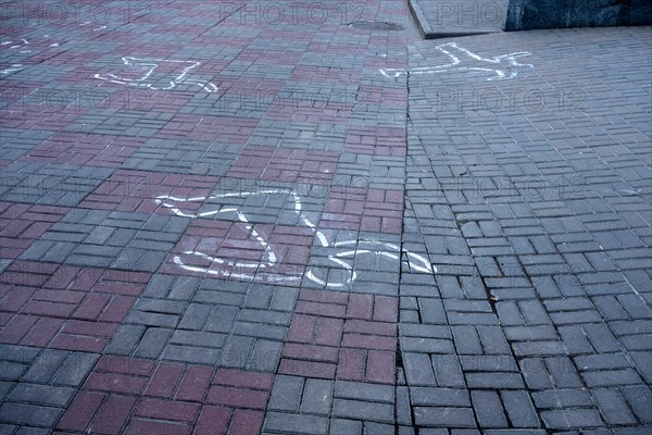 Outlines on the ground show position of dead bodies killed in the 2013/14 riots in Kiev, just in front the Dynamo Kiev Stadium, during the protests at