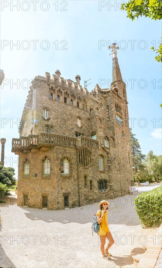 28 JULY 2018, BARCELONA, SPAIN: Tourist traveler woman enjoying view of the Bellesguard tower architecture in Barcelona