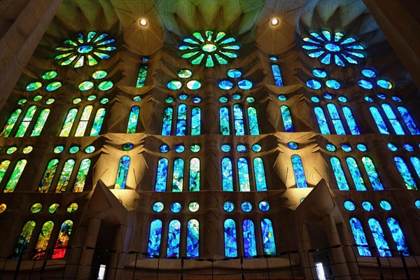 Spain, Catalonia, Barcelona, Interior of the Sagrada Familia designed by Antoni Gaudi, Nave, Passion side, Joan Vila-Grau designed stained glass .