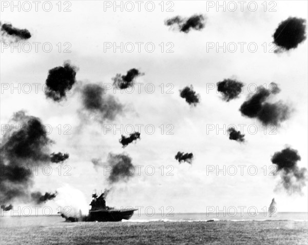 Battle of Midway, June 1942. USS Yorktown (CV-5) is hit on the port side, amidships, by a Japanese Type 91 aerial torpedo during the mid-afternoon attack by planes from the carrier Hiryu, 4 June 1942. Photographed from USS Pensacola (CA-24).