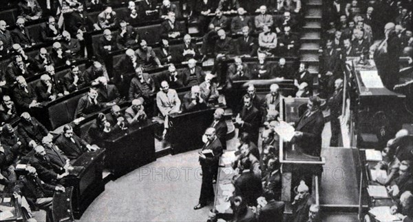 Black and white photo of French politician Edouard Herriot (1872-1957) speaking to the House of Parliament on the subject of debts to Americans.