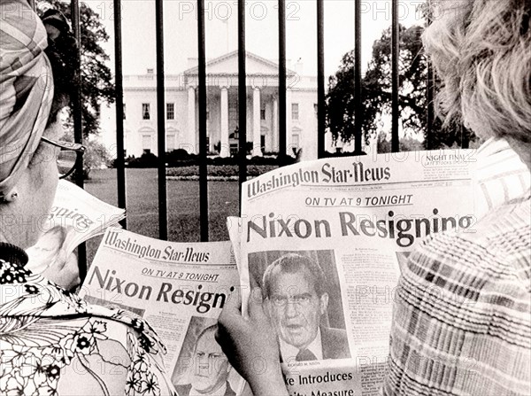People is reading newspaper's headlines in front of the White House, where is said, that President Nixon will become the first President of the countr