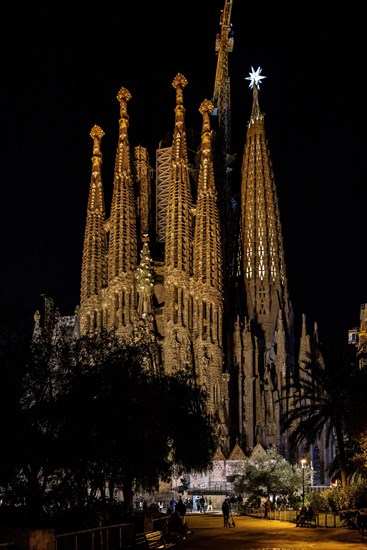 Façana del Naixement (Facade of the Birth) and the star of the Mary tower illuminated at night in the Sagrada Familia (Barcelona, Catalonia, Spain)