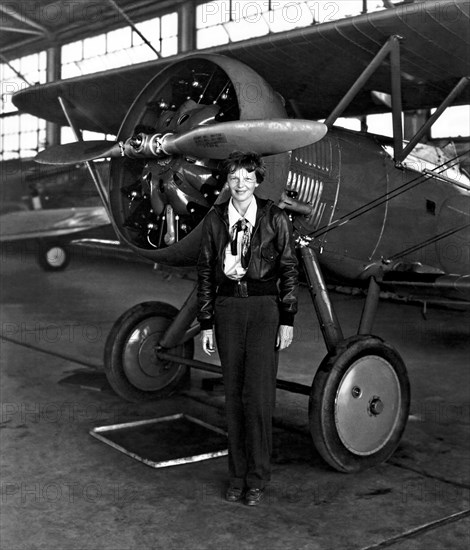 Aviation pioneer Amelia Earhart poses with her airplane in a hangar July 30, 1936. Earhart was the first female aviator to fly solo across the Atlantic Ocean