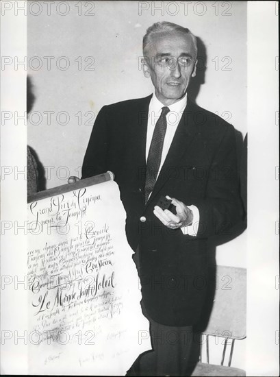 May 05, 1965 - Commandant Coustau awarded grand prix of French Cinema for youth.: Commandant Cousteau, the famous French Deep sea Explorer, was awarded the Grand Prix of French cinema for youth for his underwater films especially for the one entitied ''the Sunless World.''Photo shows Commandant Cousteau showing the gold medal and his diploma