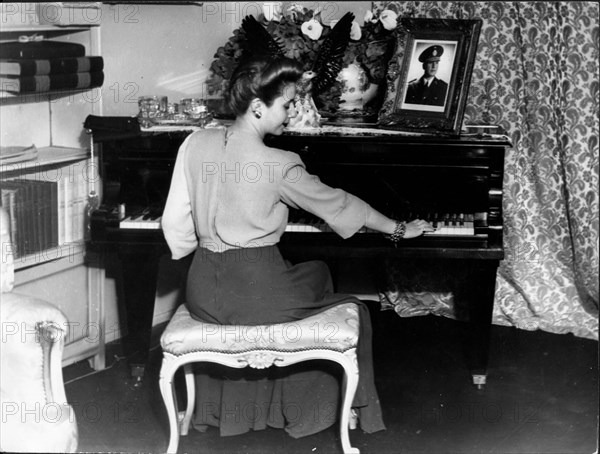 Eva Peron plays the piano at home