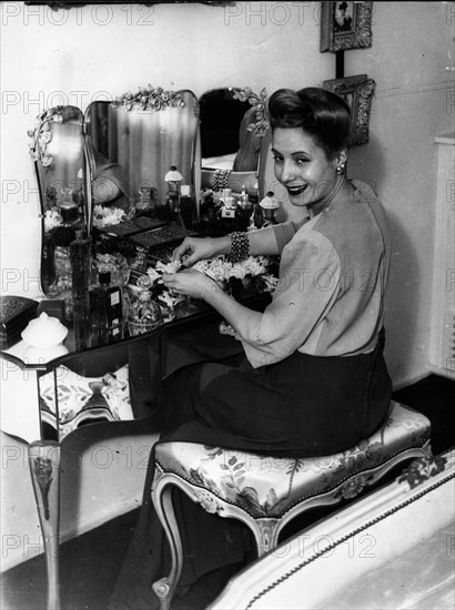 Eva Peron sitting at her dressing table