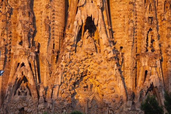 Sagrada Familia by Antoni Gaudi at sunrise in Barcelona, Catalonia, Spain. Nativity Facade, portals of Hope, Charity and Faith.