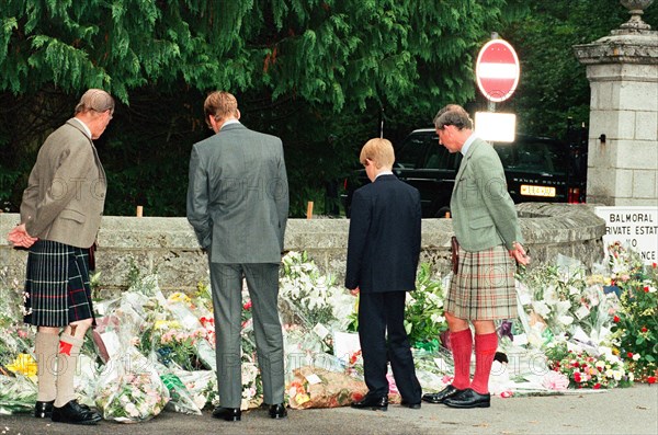 Royal Family, Balmoral Estate, Scotland, 5th September 1997.   After attending a private service at Crathie Church, Royal family stop to look at floral tributes left for Princess Diana, at the gates of Balmoral Castle.  Prince Philip Prince Charles Prince