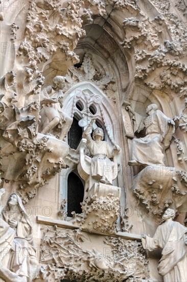 Sagrada Familia exterior, Nativity Facade, The Faith Portico, The finding in the Temple scene. Young Jesus is speaking wisely with the priests of the