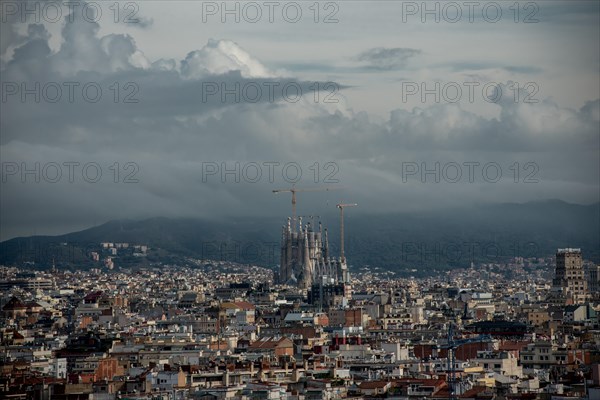 General view of Barcelona city with the Sagrada Familia emerging between the buildings.