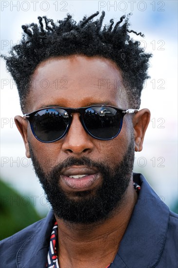 Cannes, France. 16th May 2019. Director Ladj Ly poses at a photocall for Les Miserables on Thursday 16 May 2019 at the 72nd Festival de Cannes, Palais des Festivals, Cannes. Pictured: Ladj Ly. Picture by Credit: Julie Edwards/Alamy Live News