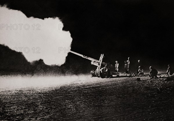 The 4.5 inch field gun bombarding enemy (German) tanks during the Second Battle of El Alamein (23 October – 11 November 1942) which prevented the Axis from advancing further into Egypt. It was a good weapon that could fire a 25 kg  shell up to 11.6 miles matching German 10.5 cm and 150 mm howitzers in range and firepower.