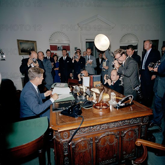18 October 1962
Proclamation signing, Interdiction of the Delivery of Offensive Weapons to Cuba, 7:05PM
[Scratch down the right side of the image original to negative.]

Please Credit. "Robert Knudsen. White House Photographs. John F. Kennedy Presidential Library and Museum, Boston"