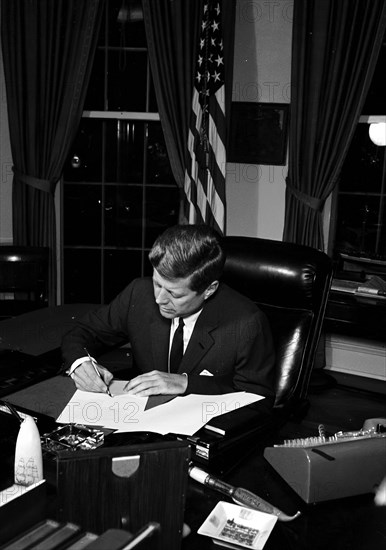 23 October 1962
Proclamation signing, Interdiction of the Delivery of Offensive Missiles to Cuba, 7:05PM.
[White spotting throughout negative.]

Please credit "Cecil Stoughton. White House Photographs. John F. Kennedy Presidential Library and Museum, Boston."