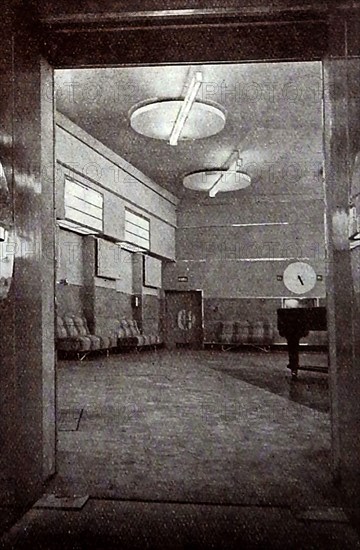 A very early printed photograph of BBC's Studio used for broadcasting concerts and musical shows. The BBC began  daily radio services in London  in the 1920s on the radio station 2LO. Under the general management of 33 year old John Charles Walsham Reith  the BBC  began to expand its programmes on 14 December 1922. The  first chief engineer was Peter Eckersley. 1927 saw the establishment of British Broadcasting Corporation  by Royal Charter with  Reith as its first Director-General.  John Logie Baird began experimenting  with television broadcasts on BBC frequencies in November 1929.