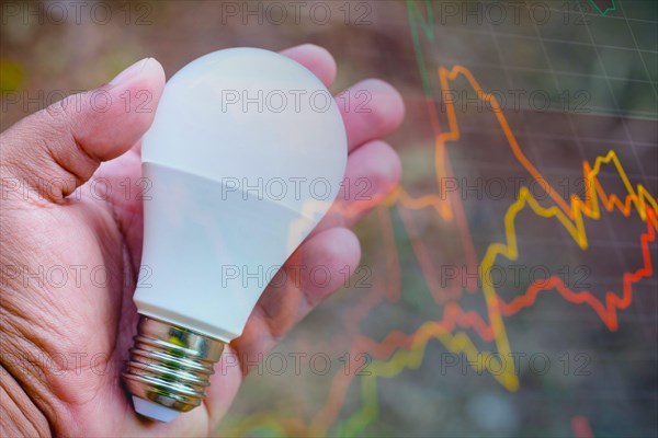 Brazil. 17th Aug, 2021. In this photo illustration a hand holding a LED light bulb (light-emitting diodes). Electricity price concept, readjustment in the electricity bill. Credit: SOPA Images Limited/Alamy Live News
