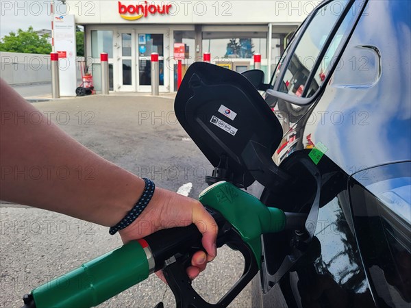PARIS, FRANCE - JUNE 2022: Refueling a car with E10 super at a french gas station