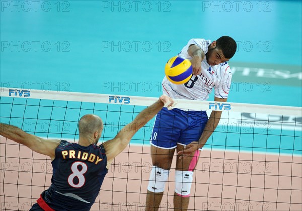 Ngapeth Earvin of France (R) spikes the ball while Priddy William of USA tries to block during the match USA v France