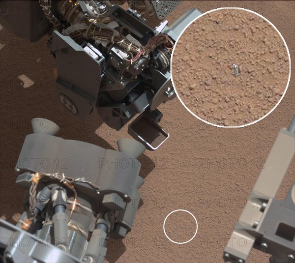 View of Curiosity's First Scoop Also Shows Bright Object This image from the right Mast Camera (Mastcam) of NASA's Mars rover Curiosity shows a scoop full of sand and dust lifted by the rover's first use of the scoop on its robotic arm. In the foreground, near the bottom of the image, a bright object is visible on the ground. The object might be a piece of rover hardware. This image was taken during the mission's 61st Martian day, or sol (Oct. 7, 2012), the same sol as the first scooping. After examining Sol 61 imaging, the rover team decided to refrain from using the arm on Sol 62 (Oct. 8). Instead, the rover was instructed to acquire additional imaging of the bright object, on Sol 62, to aid the team in assessing possible impact, if any, to sampling activities.

For scale, the scoop is 1.8 inches (4.5 centimeters) wide, 2.8 inches (7 centimeters) long.