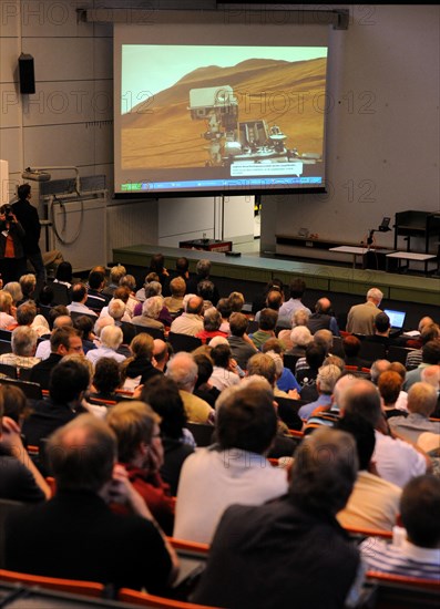 Scientists, students and family members follow the broadcasting of the Mars landing of the Curiosits robot, at the University in Kiel, Germany, 06 August 2012. The Curiosity robot is equipped with a nuclear-powered lab capable of vaporizing rocks and ingesting soil, measuring habitability, and potentially paving the way for human exploration. The University of Kiel contributed to t