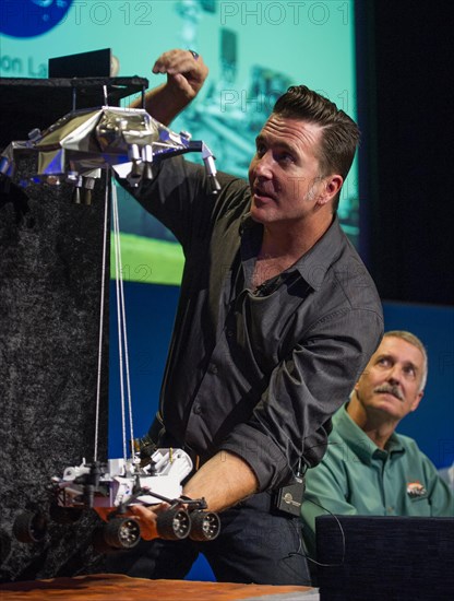Adam Steltzner, Mars Science Laboratory (MSL) entry, descent and landing phase lead, Jet Propulsion Laboratory, demonstrates how the MSL spacecraft will land the Curiosity rover on Mars during a briefing held at the Jet Propulsion Laboratory on Thursday, August 2, 2012 in Pasadena, Calif. The MSL Rover named Curiosity was designed to assess whether Mars ever had an environment able to support small life forms called microbes. Curiosity is due to land on Mars at 10:31 p.m. PDT on Aug. 5, 2012 (1:31 a.m. EDT on Aug. 6, 2012). Photo Credit: (NASA/Bill Ingalls) Adam Steltzner at MSL Briefing (2012