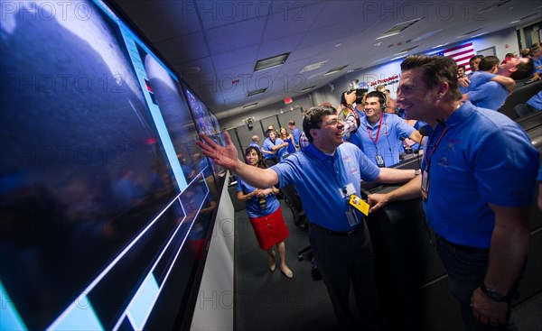 Christopher J. Scolese, Director of NASA's Goddard Space Flight Center, left, congratulates, MSL Entry, Descent and Landing Engineer Adam Steltzner as they look at the first images of Mars to come from the Curiosity rover shortly after it landed on Mars, Sunday, Aug. 5, 2012 at the Jet Propulsion Laboratory in Pasadena, Calif. Curiosity was designed to assess whether Mars ever had an environment able to support small life forms called microbes.  Photo Credit: (NASA/Bill Ingalls) Mars Science Laboratory (MSL) - Flickr - NASA Goddard Photo and Video