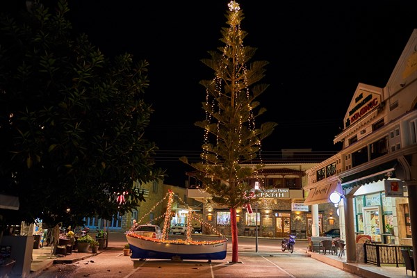 Wooden Christmas ship decorated at night. In the Greek tradition (especially in the islands) it is common to ornament a ship instead of a tree.