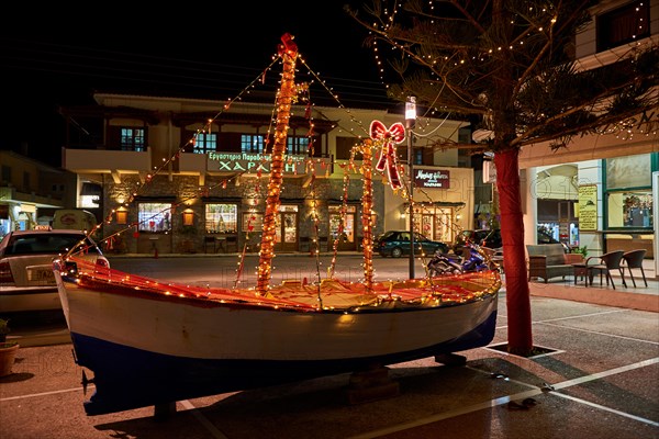 Wooden Christmas ship decorated at night. In the Greek tradition (especially in the islands) it is common to ornament a ship instead of a tree for Ch