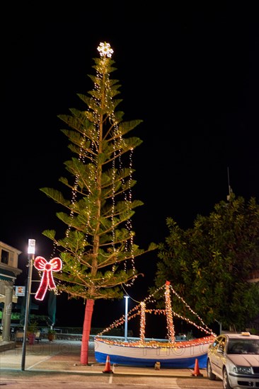 Wooden Christmas ship decorated at night. In the Greek tradition (especially in the islands) it is common to ornament a ship instead of a tree.