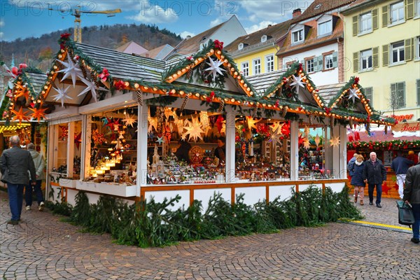 Beautiful colorful sales booth selling seasonal decoration objects at traditional Christmas market in Heideberg city center