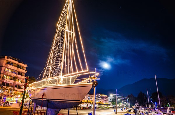 Iconic view of a decorated wooden sailing boat during Christmas period against a starry night in Kalamata city, Messenia, Greece