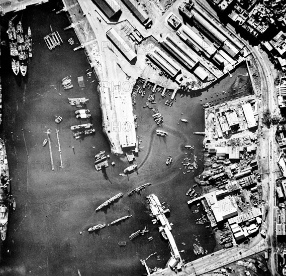 Aerial view of the port of Casablanca, Morocco, at the time of the Allied landings in North Africa. Note the sunken ship in the center of the harbour and the French battleship Jean Bart on the left. November 9, 1942
