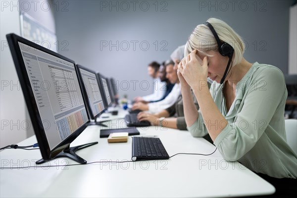 Young Depressed Businesswoman Sitting At Office Desk