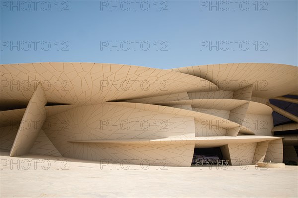 Modern contemporary architecture National Museum of Qatar by Jean Nouvel in Doha city with blue sky backgound