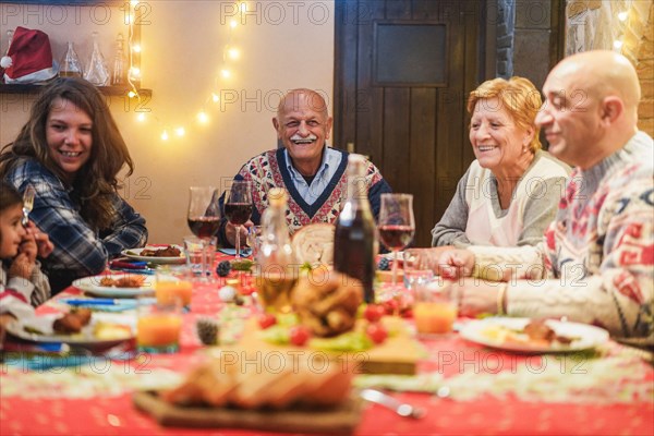 Happy family having Christmas dinner at home - Holiday concept - Focus on grandfather