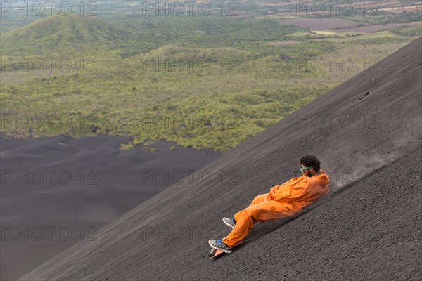 A Volcano surfer slides down Cerro Negro Volcano.