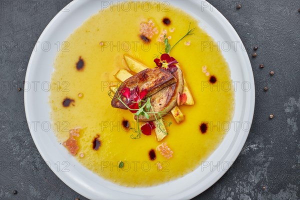 Foie gras, fuagra, with sauce, on a white plate