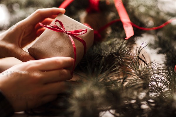 Femele hands holding christmas gift. Ideas for christmas decoration and gifts. Christmas and New year concept.