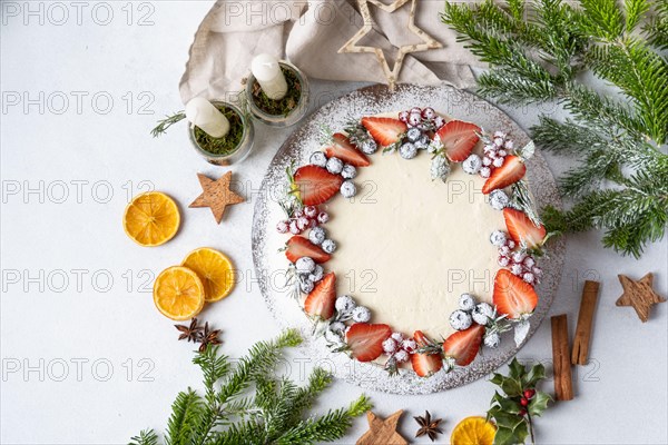 Homemade birthday cake for New year and Christmas. Christmas tree branches for decorating the Christmas table.