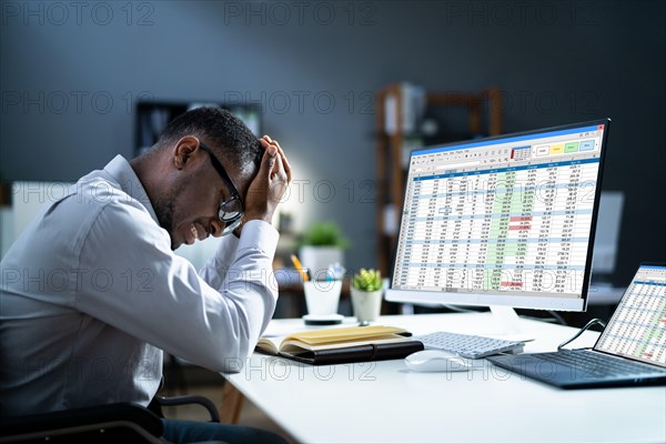 Stressed Depressed African Man At Desk. Tired Bored Businessman