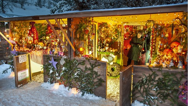 Romantic christmas market in Bavaria with illuminated wooden shops in snow