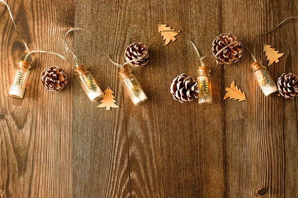 Concept - Christmas wood background with lights and tree with copy space, flat lay